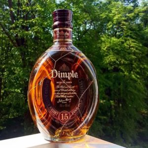 Discover the smooth taste of Dimple Pinch Scotch Whisky. Aged 15 years, this premium blend delivers rich flavor and refined quality in every sip